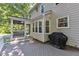 Exterior view of a gray deck with a screened porch and a covered grill at 2125 Oakcrest Ct, Raleigh, NC 27612
