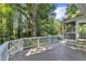 A spacious deck with white railings and a screened porch for outdoor relaxation at 2125 Oakcrest Ct, Raleigh, NC 27612