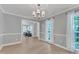 Bright dining room features light wood floors, chandelier, and large windows with sheer curtains at 2125 Oakcrest Ct, Raleigh, NC 27612
