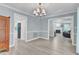 Dining room with light wood floors and view of kitchen and living room at 2125 Oakcrest Ct, Raleigh, NC 27612