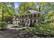 Beautifully landscaped brick home with attached garage, mature trees and welcoming entryway at 2125 Oakcrest Ct, Raleigh, NC 27612