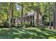 Traditional brick home with lush green lawn and mature trees offering shade at 2125 Oakcrest Ct, Raleigh, NC 27612