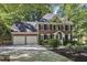 Charming brick home featuring an attached two car garage and well-manicured landscaping at 2125 Oakcrest Ct, Raleigh, NC 27612