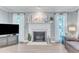 Living room fireplace with white mantel, tile surround and flanking windows at 2125 Oakcrest Ct, Raleigh, NC 27612