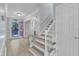 Bright foyer with light wood floors, neutral paint, staircase and a view to the front door at 2125 Oakcrest Ct, Raleigh, NC 27612