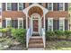 Inviting front entrance with a brick walkway, a charming porch and sidelight windows at 2125 Oakcrest Ct, Raleigh, NC 27612