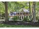 Traditional brick home with a manicured front yard and mature trees at 2125 Oakcrest Ct, Raleigh, NC 27612