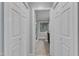 Hallway between closets leading to a bathroom with a glass shower at 2125 Oakcrest Ct, Raleigh, NC 27612