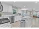 Bright eat-in kitchen featuring stainless steel appliances, granite counters, and white cabinets at 2125 Oakcrest Ct, Raleigh, NC 27612