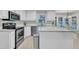 Kitchen with stainless steel appliances, white cabinets, granite countertops, and a center island at 2125 Oakcrest Ct, Raleigh, NC 27612