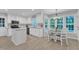 Open kitchen features stainless appliances, granite countertops, white cabinets and a breakfast nook at 2125 Oakcrest Ct, Raleigh, NC 27612