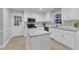Modern kitchen with white cabinets, granite countertops, stainless steel appliances, and a center island at 2125 Oakcrest Ct, Raleigh, NC 27612