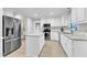 Bright, updated kitchen with stainless steel appliances, white cabinets, granite countertops, and an island at 2125 Oakcrest Ct, Raleigh, NC 27612