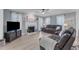 Comfortable living room featuring a fireplace, ceiling fan, and neutral walls at 2125 Oakcrest Ct, Raleigh, NC 27612