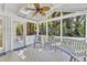 Bright screened porch with skylights, wood decking, fan and views of the wooded backyard at 2125 Oakcrest Ct, Raleigh, NC 27612