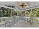 Inviting screened-in porch with comfortable seating and tranquil views of the wooded backyard at 2125 Oakcrest Ct, Raleigh, NC 27612