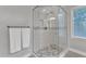 Glass shower with patterned floor tiles and a window at 2125 Oakcrest Ct, Raleigh, NC 27612