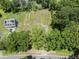 Overhead view of home and expansive yard with mature trees and a convenient paved road at 218 Mason Rd, Durham, NC 27712