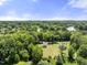 Scenic aerial view of home surrounded by lush greenery, lakes and the rest of the community at 218 Mason Rd, Durham, NC 27712
