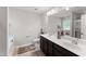 Spacious bathroom with double sink vanity, large mirror, and neutral decor at 218 Mason Rd, Durham, NC 27712