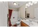 Bright bathroom featuring a shower-tub combo, neutral walls, and classic fixtures at 218 Mason Rd, Durham, NC 27712