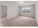 Neutral bedroom with lots of natural light, neutral carpet, and view to the backyard at 218 Mason Rd, Durham, NC 27712