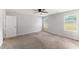 Spacious bedroom featuring neutral walls, carpet floors, and a ceiling fan for added comfort at 218 Mason Rd, Durham, NC 27712