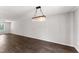 Dining room with a modern chandelier, hardwood floors and neutral walls ready for customization at 218 Mason Rd, Durham, NC 27712