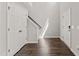 Inviting entryway with hardwood flooring and convenient coat closet near the staircase at 218 Mason Rd, Durham, NC 27712