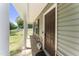 Charming front porch with classic columns, natural stone accents, and a welcoming dark-stained front door at 218 Mason Rd, Durham, NC 27712