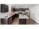 Modern kitchen with dark cabinets, stainless steel appliances, granite countertops and island at 218 Mason Rd, Durham, NC 27712