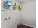 Functional laundry room with storage shelves, connections for a washer and dryer, and clean white walls at 218 Mason Rd, Durham, NC 27712