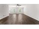 Living room boasts natural light, wood floors, and ceiling fan, creating a relaxing ambiance at 218 Mason Rd, Durham, NC 27712