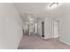 Upstairs hallway featuring neutral carpet, doors and a window view to the backyard at 218 Mason Rd, Durham, NC 27712