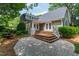 Backyard view of a charming home with a stone patio, deck and a water feature at 2202 St Marys St, Raleigh, NC 27608