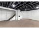 Finished basement with carpet, exposed beams and white painted brick column at 2202 St Marys St, Raleigh, NC 27608