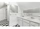 Bathroom with double sinks, white cabinets, checkerboard flooring and a bright window at 2202 St Marys St, Raleigh, NC 27608