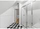 Bathroom featuring a glass shower door and black-and-white tiled floors at 2202 St Marys St, Raleigh, NC 27608