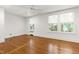 Sunlit bedroom featuring beautiful hardwood floors and multiple windows at 2202 St Marys St, Raleigh, NC 27608