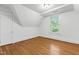 Well-lit bedroom with hardwood floors, white walls, a window and a closet at 2202 St Marys St, Raleigh, NC 27608