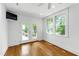 Bright bedroom featuring hardwood floors, white walls, and glass doors to a deck at 2202 St Marys St, Raleigh, NC 27608