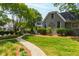 Well-manicured lawn and charming home with decorative brick and lush trees at 2202 St Marys St, Raleigh, NC 27608