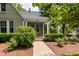Inviting front porch with brick walkway, white columns and lush landscaping at 2202 St Marys St, Raleigh, NC 27608
