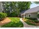 Charming home featuring a lush green lawn and a brick walkway leading to the front door at 2202 St Marys St, Raleigh, NC 27608