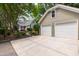 Spacious three-car garage and house with beautifully landscaped yard and a secure black metal fence at 2202 St Marys St, Raleigh, NC 27608
