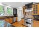 Gourmet kitchen featuring stainless steel appliances and custom cabinetry at 2202 St Marys St, Raleigh, NC 27608