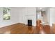 Bright living room with fireplace, hardwood floors and view of the staircase at 2202 St Marys St, Raleigh, NC 27608