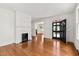 Bright living room with hardwood floors, white fireplace, and stained glass front door at 2202 St Marys St, Raleigh, NC 27608