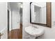 Charming powder room features classic sink, decorative mirror, and hardwood floors at 2202 St Marys St, Raleigh, NC 27608