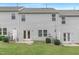 Townhome backyard, grass lawn, and rear exterior of the unit, featuring glass doors and landscape at 222 Explorer Dr # 271, Morrisville, NC 27560